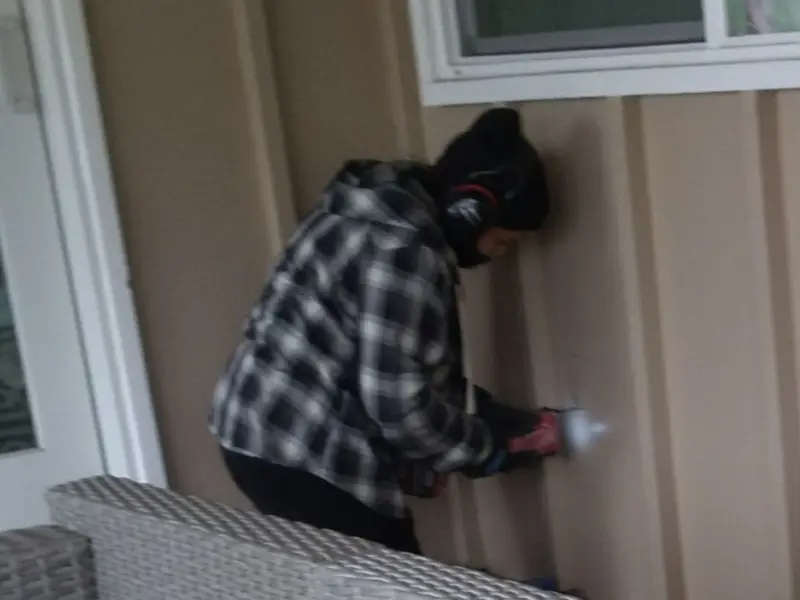 Professional electrician installing an exterior outlet in West New York